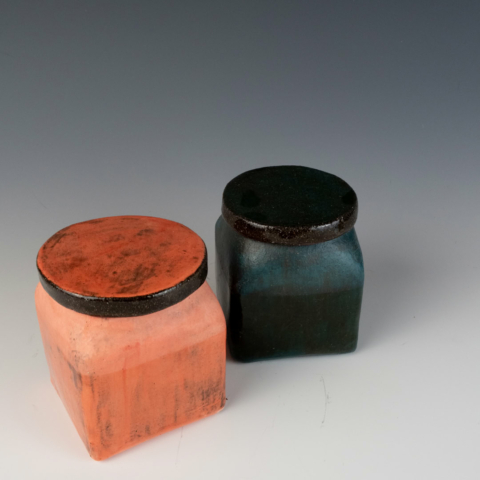 Two lidded jars, one pink, one blue. Terra Sigillata surface.