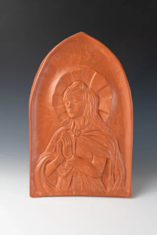 Bas relief of a medieval woman looking toward heaven