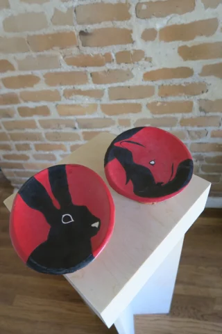 Two plates one with a fox, one with a hare